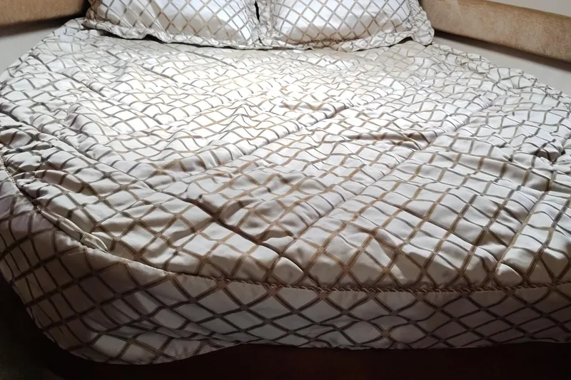 Slide: The Image of Luxurious bed with patterned bedding inside a 2007 Meridian 341 Sedan yacht. - 8
