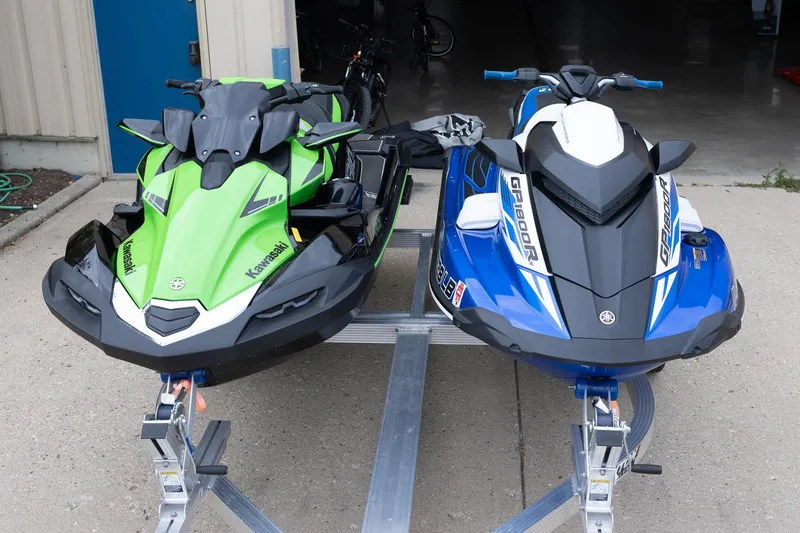 Slide: The Image of Two jet skis on trailers: a green Kawasaki and a blue 2021 Yamaha WaveRunner GP1800R SVHO. - 10