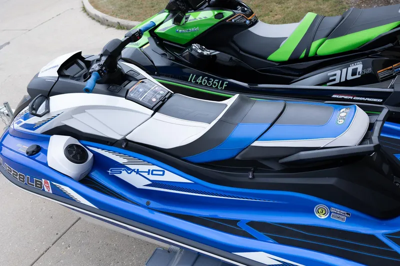 Slide: The Image of 2021 Yamaha WaveRunner GP1800R SVHO jet ski in blue and white, parked on pavement. - 11