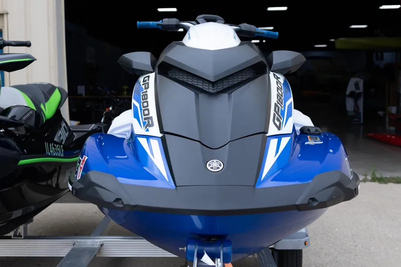 Slide: The Image of 2021 Yamaha WaveRunner GP1800R SVHO in blue, parked outside a garage. - 9