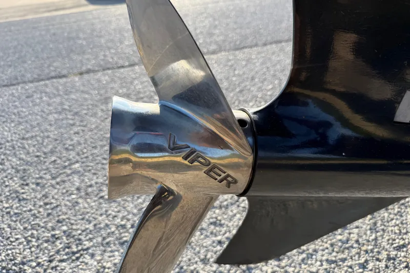 Slide: The Image of 2013 Ranger Z117 boat with Evinrude engine on trailer in parking lot. - 12