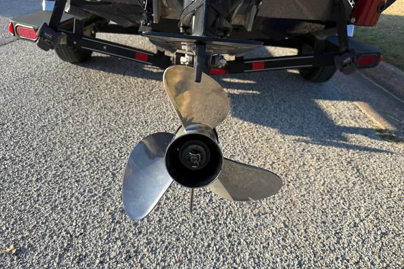 Slide: The Image of 2013 Ranger Z117 boat with Evinrude motor on trailer near water. - 13