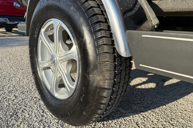 Slide: The Image of 2013 Ranger Z117 boat on trailer by lake, attached to red truck. - 15