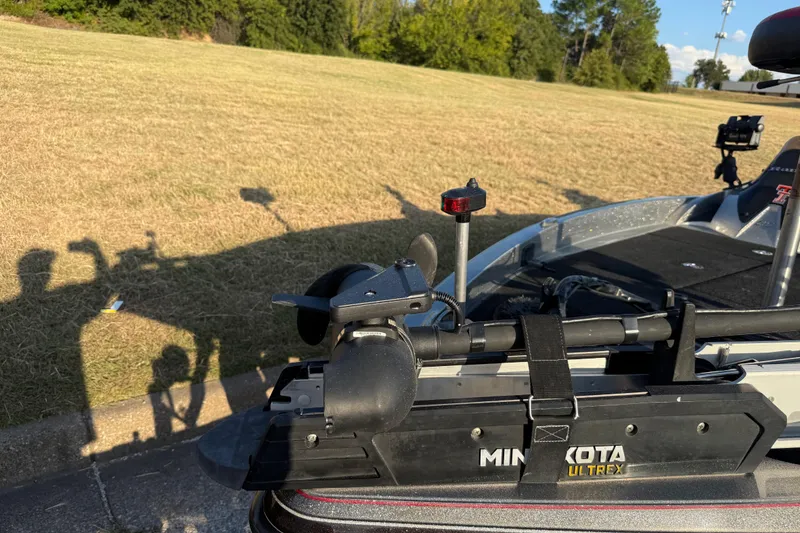 Slide: The Image of 2013 Ranger Z117 boat on trailer by the water, featuring Minn Kota motor. - 18