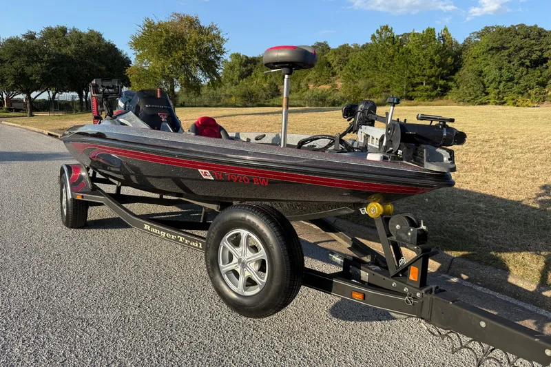 Slide: The Image of 2013 Ranger Z117 boat with Minn Kota Ultrex trolling motor at a lakeside dock. - 19