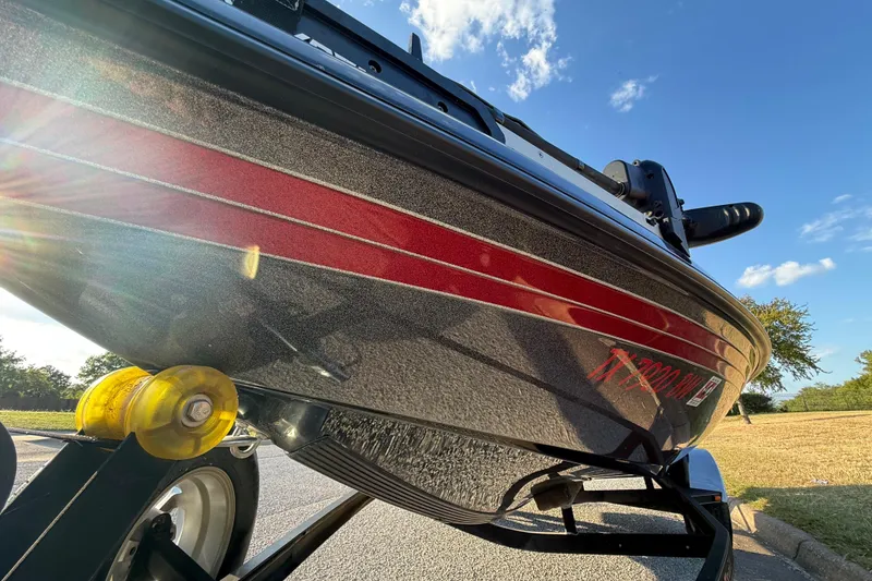 Slide: The Image of 2013 Ranger Z117 boat with Evinrude engine on trailer, parked on roadside. - 33