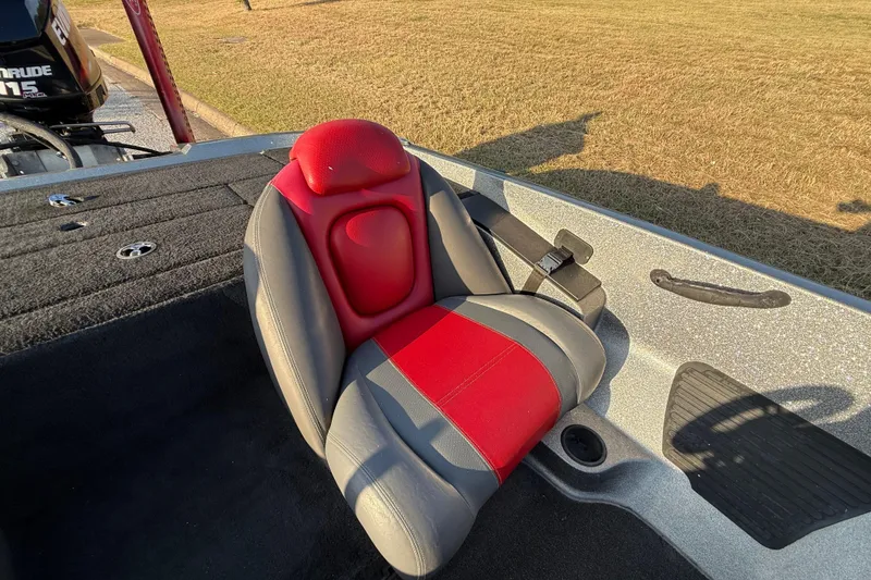 Slide: The Image of Open storage compartment in 2013 Ranger Z117 boat, featuring carpeted interior and rod holders. - 41