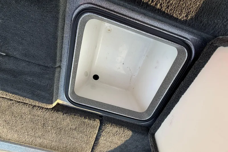 Slide: The Image of 2013 Ranger Z117 boat interior with red and gray seat, steering wheel, and dashboard controls. - 44