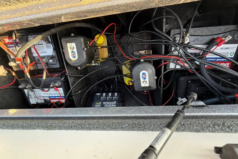 Slide: The Image of 2013 Ranger Z117 boat interior with red and gray seats, Evinrude motor visible. - 45