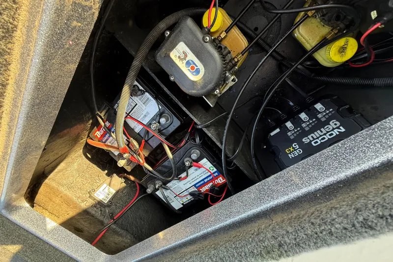 Slide: The Image of 2013 Ranger Z117 boat seat with red and gray upholstery, Evinrude motor visible. - 46