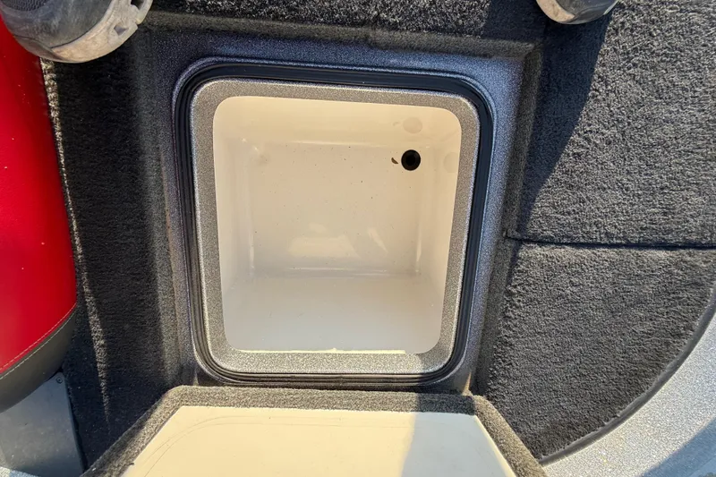 Slide: The Image of Interior of a 2013 Ranger Z117 boat with steering wheel and control panel. - 48