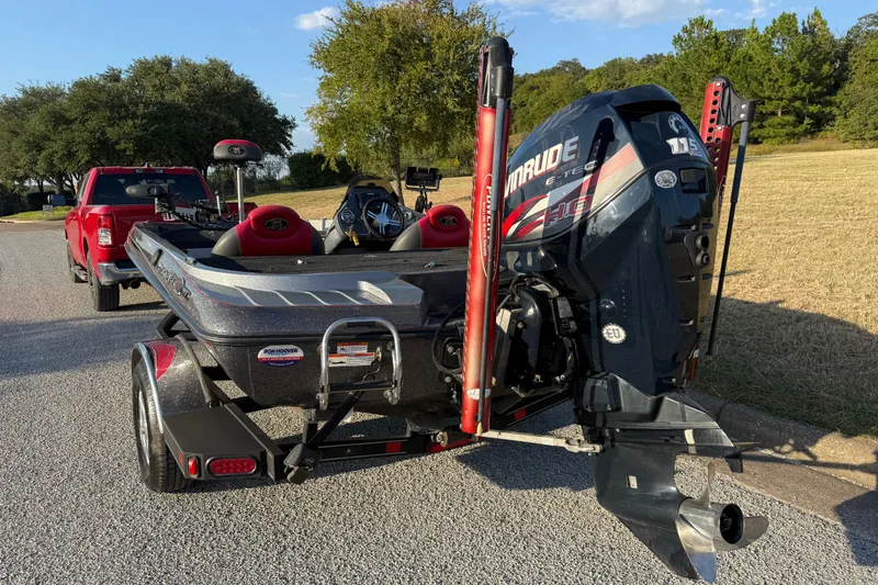 Slide: The Image of 2013 Ranger Z117 boat on trailer, parked near water, with Evinrude motor. - 6