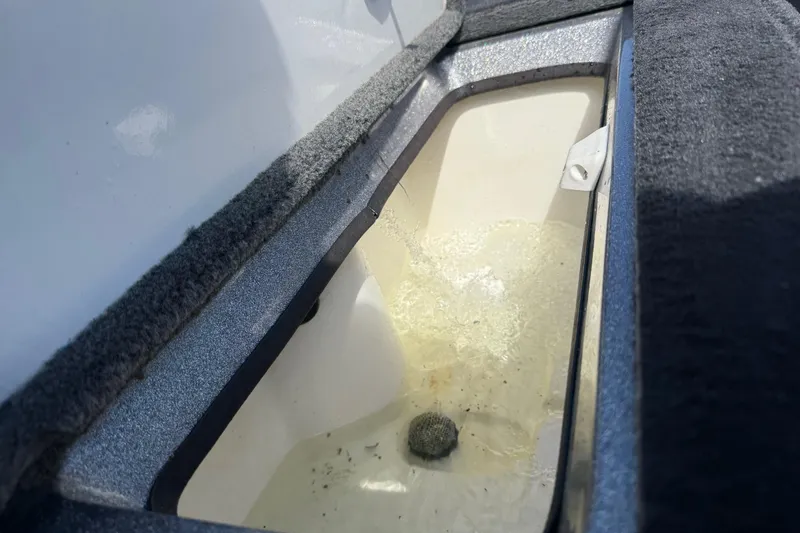 Slide: The Image of Interior view of a 2013 Ranger Z117 boat compartment with water inside. - 62