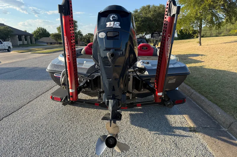 Slide: The Image of 2013 Ranger Z117 boat with Evinrude engine on trailer, parked near red truck. - 8
