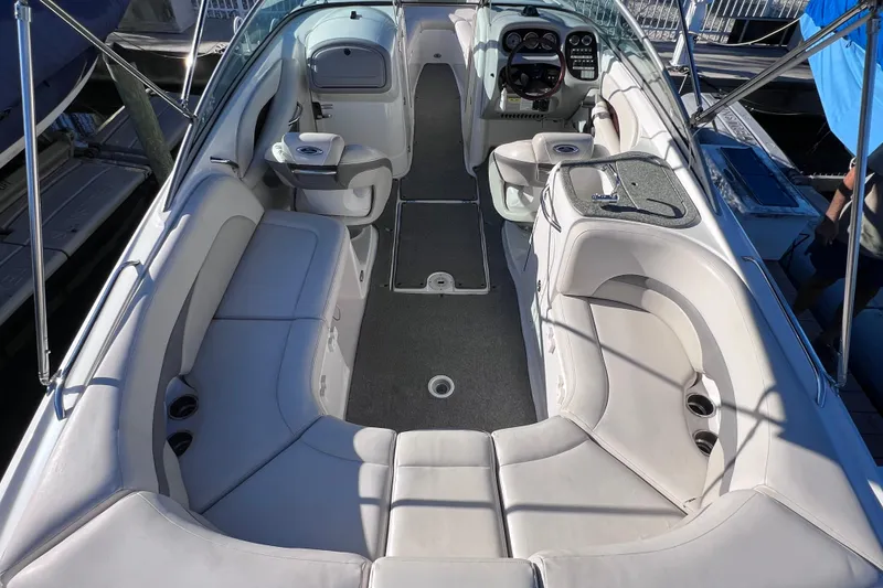 Slide: The Image of 2006 Chaparral 256 SSi boat interior with white seating and modern dashboard. - 10