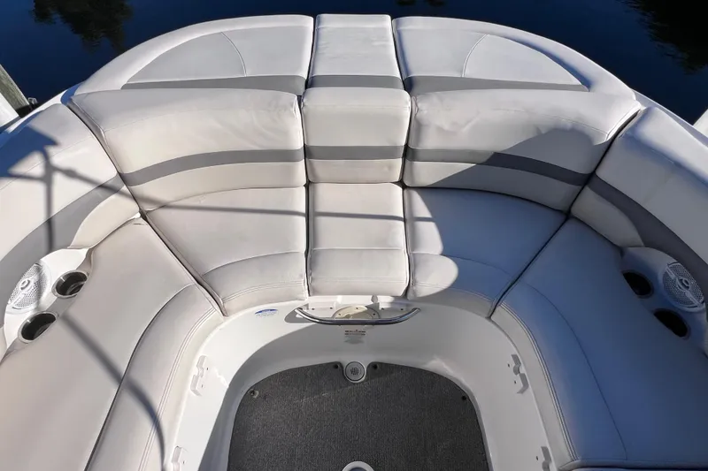 Slide: The Image of 2006 Chaparral 256 SSi boat interior with cushioned seating and cup holders. - 11