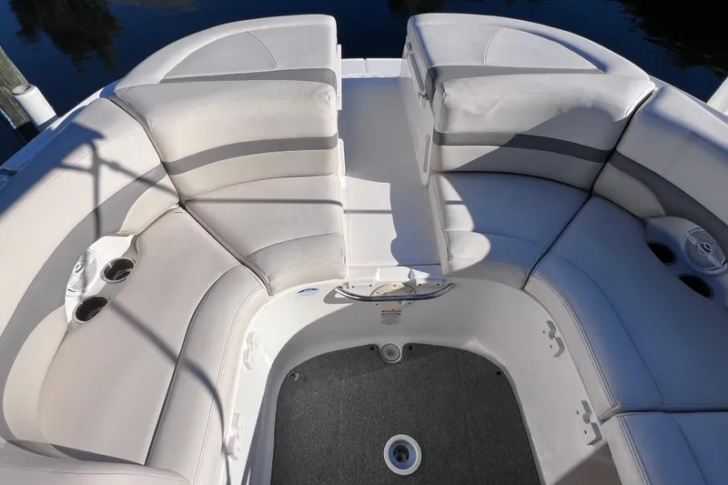 Slide: The Image of 2006 Chaparral 256 SSi boat interior with cushioned seating and cup holders. - 12