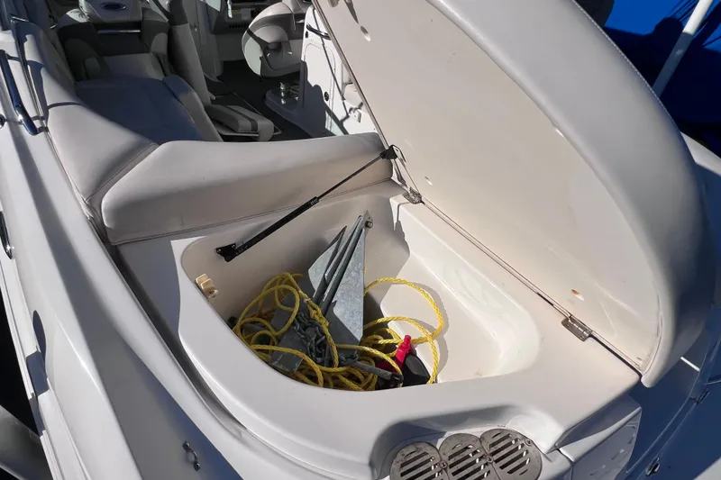 Slide: The Image of Open storage compartment on 2006 Chaparral 256 SSi boat with anchor and rope. - 13