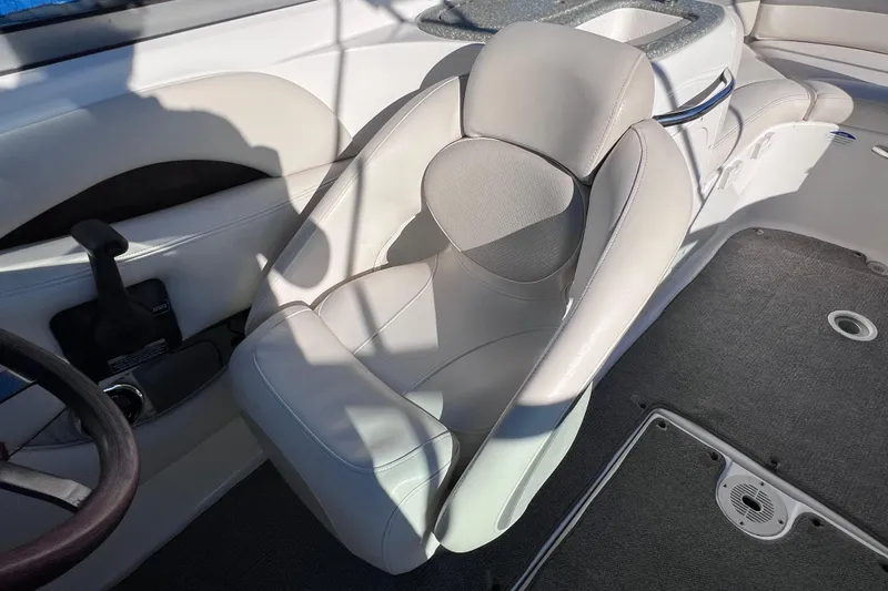 Slide: The Image of 2006 Chaparral 256 SSi boat interior with beige captain's seat and steering wheel. - 17