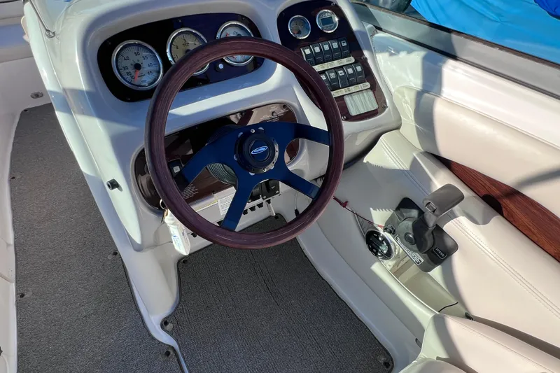 Slide: The Image of 2006 Chaparral 256 SSi boat dashboard with steering wheel and control panel. - 19
