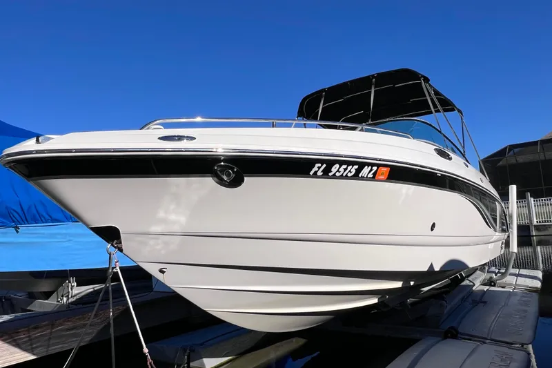 Slide: The Image of 2006 Chaparral 256 SSi boat docked under clear blue sky. - 2