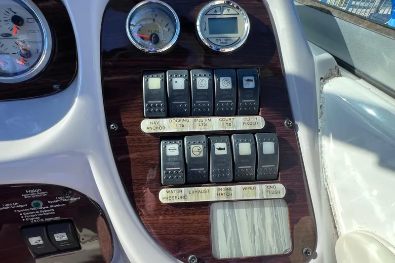Slide: The Image of Dashboard controls of a 2006 Chaparral 256 SSi boat with various switches and gauges. - 20
