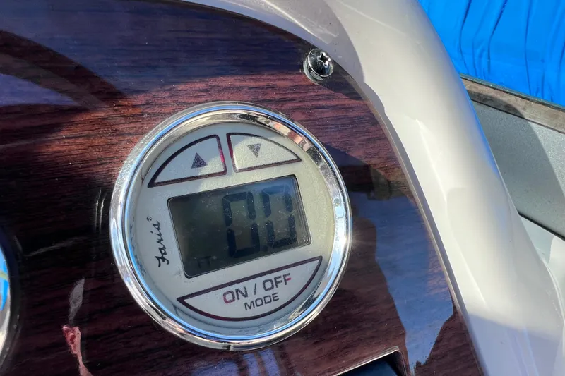 Slide: The Image of Close-up of a Faria gauge on a 2006 Chaparral 256 SSi boat dashboard. - 23