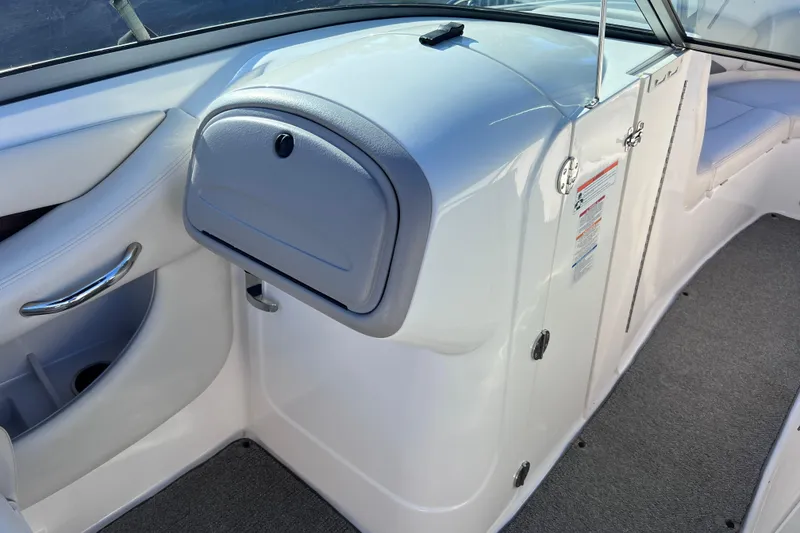 Slide: The Image of 2006 Chaparral 256 SSi boat interior with glove compartment and seating area. - 26