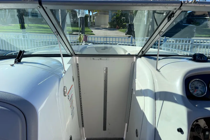Slide: The Image of 2006 Chaparral 256 SSi boat interior with windshield and dashboard view. - 28