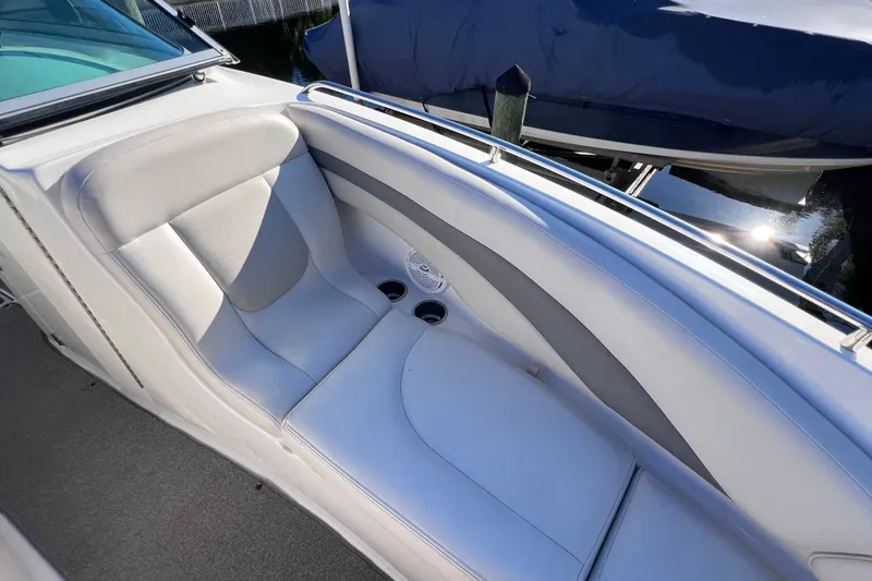 Slide: The Image of 2006 Chaparral 256 SSi boat interior with white seating and cup holders. - 31