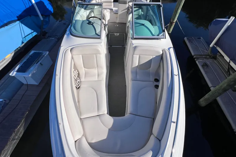 Slide: The Image of 2006 Chaparral 256 SSi boat with spacious seating and sleek design at dock. - 34