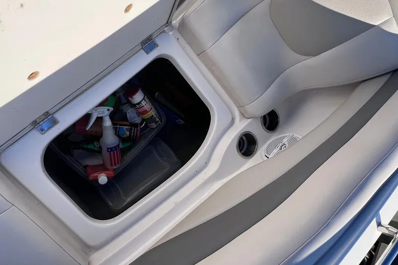 Slide: The Image of Storage compartment in a 2006 Chaparral 256 SSi boat with cleaning supplies. - 36