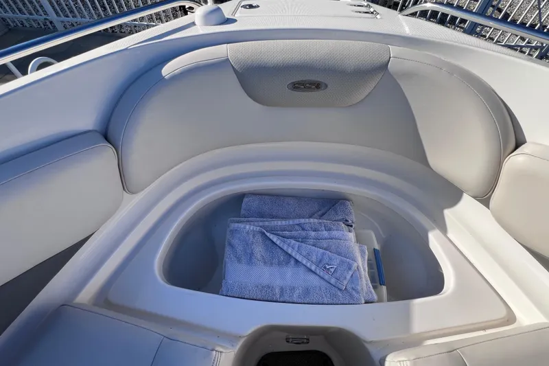 Slide: The Image of 2006 Chaparral 256 SSi boat interior with storage compartment and blue towels. - 37
