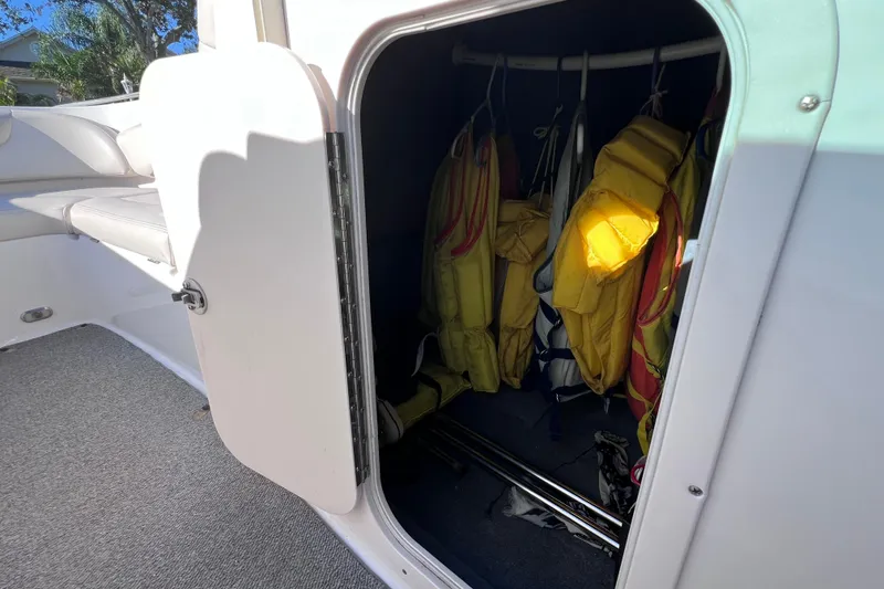 Slide: The Image of Storage compartment on a 2006 Chaparral 256 SSi boat with life jackets inside. - 38