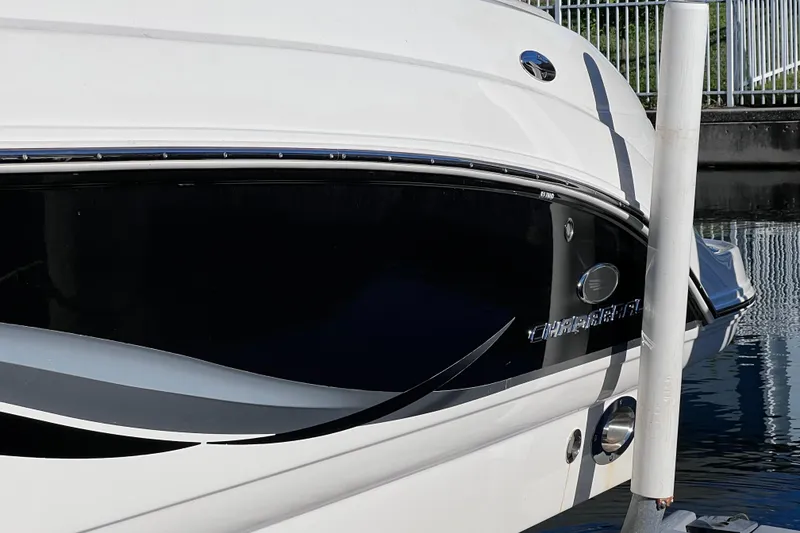 Slide: The Image of 2006 Chaparral 256 SSi boat docked, showcasing sleek design and branding. - 4