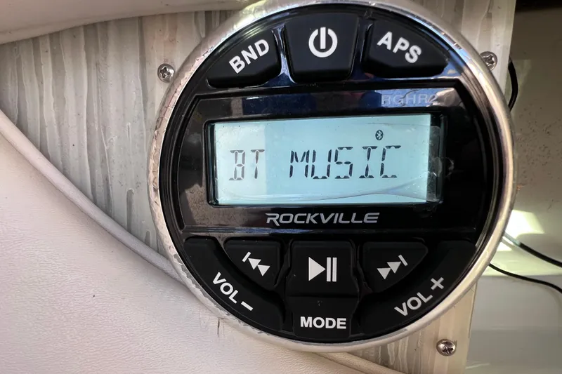Slide: The Image of Rockville audio system displaying "BT Music" in a 2006 Chaparral 256 SSi boat. - 46