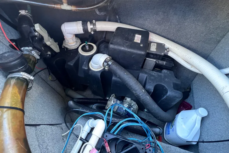 Slide: The Image of Engine compartment of a 2006 Chaparral 256 SSi boat, showing hoses and wiring. - 48