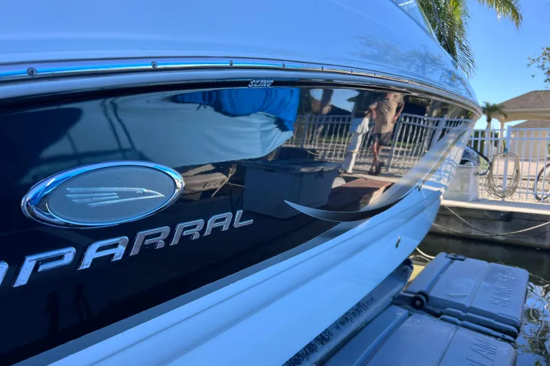 Slide: The Image of 2006 Chaparral 256 SSi boat side view with logo and dock reflection. - 6