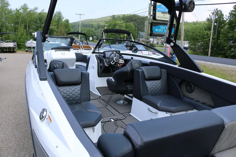 Slide: The Image of 2026 Scarab 255 LX boat with modern interior design and seating, displayed outdoors. - 10