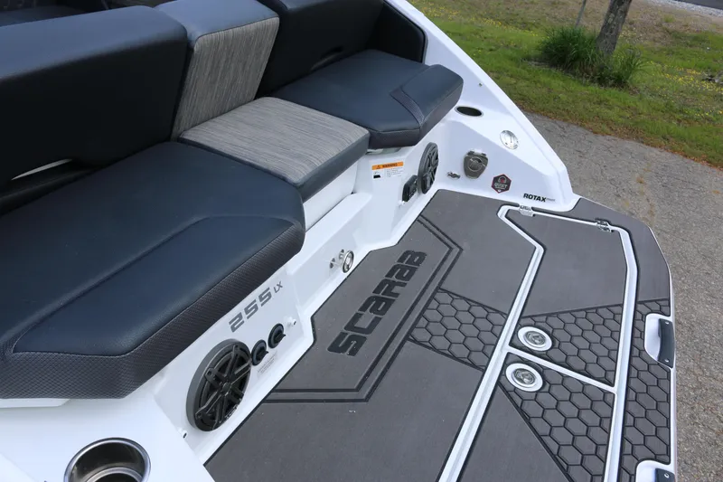 Slide: The Image of 2026 Scarab 255 LX boat interior with cushioned seating and sleek design. - 11