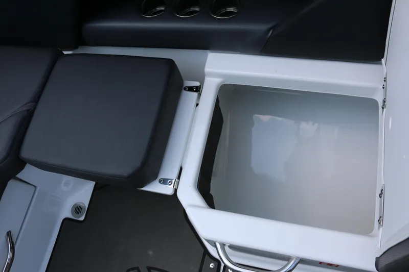 Slide: The Image of 2026 Scarab 255 LX boat storage compartment with cushioned seating and sleek design. - 15