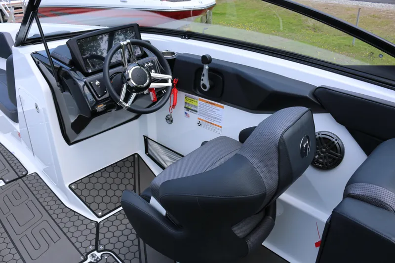 Slide: The Image of 2026 Scarab 255 LX boat interior with steering wheel and modern dashboard controls. - 20