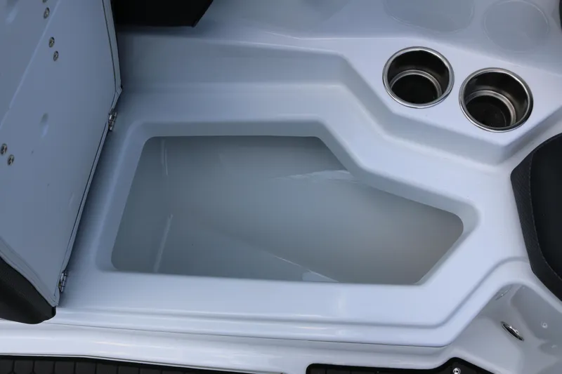 Slide: The Image of 2026 Scarab 255 LX boat interior with storage compartment and cup holders. - 23