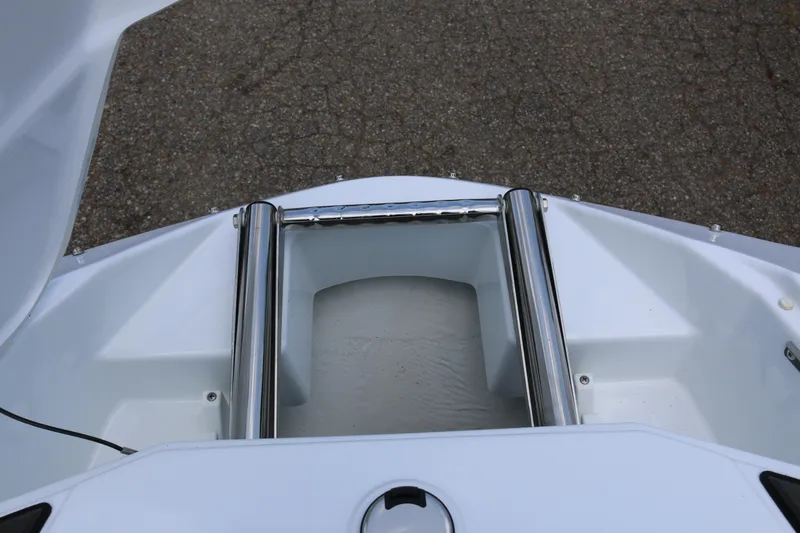 Slide: The Image of 2026 Scarab 255 LX boat bow with stainless steel fittings and storage compartment. - 26
