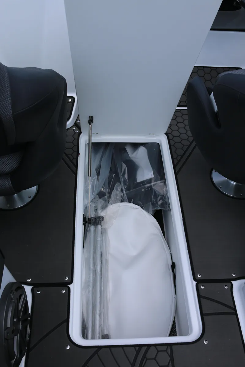Slide: The Image of 2026 Scarab 255 LX boat storage compartment with seating and equipment. - 27