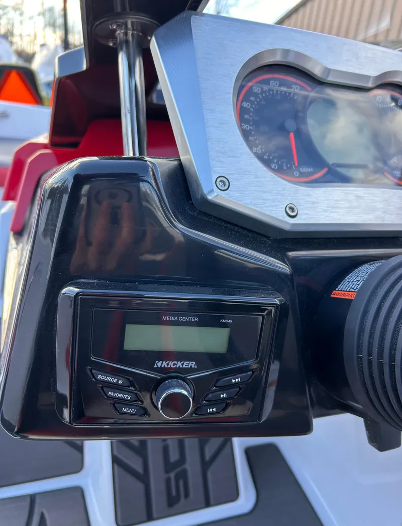 Slide: The Image of 2025 Scarab 165 LX dashboard with Kicker audio system and speedometer. - 17