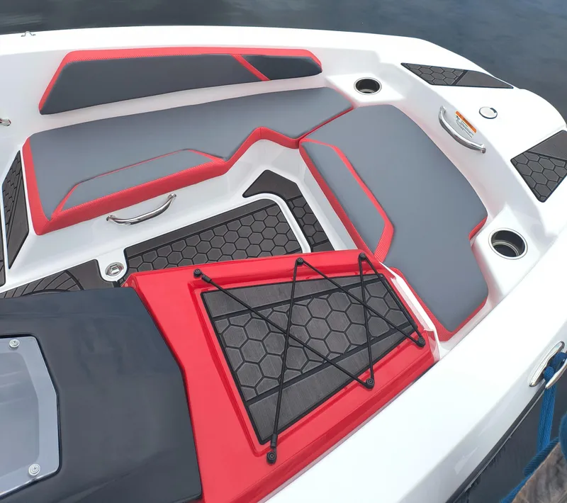 Slide: The Image of 2025 Scarab 165 LX boat interior with red and gray seating, hexagonal pattern flooring. - 4
