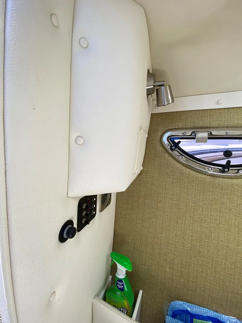 Slide: The Image of Interior of a 2019 Cobalt R7 boat with a small window and storage compartment. - 12