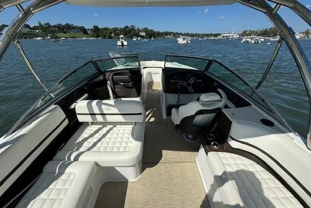 Slide: The Image of 2019 Cobalt R7 boat interior with white seating, on a sunny day, surrounded by water and other boats. - 3