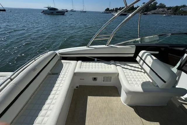 Slide: The Image of 2019 Cobalt R7 boat interior with white seating, overlooking a serene lake view. - 4